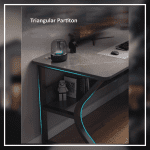 A modern gaming desk setup featuring a sleek, gray desk with a curved black frame. The desk holds a monitor displaying a mountain landscape, a keyboard, a mouse, and various accessories. A gaming PC with blue LED lights is positioned underneath. The wall has a pegboard with a digital clock and other items.