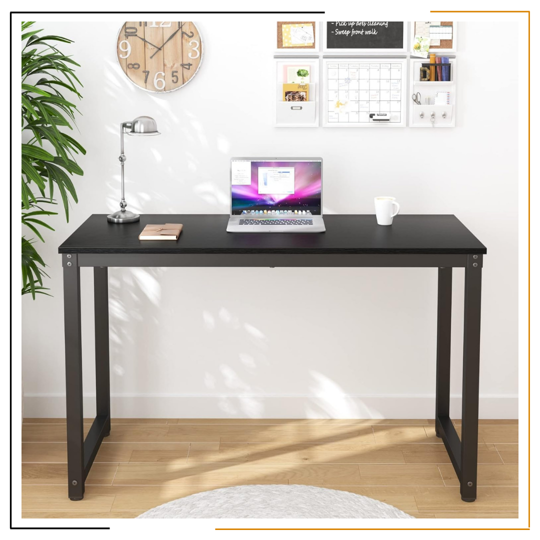 Modern Minimalist Black Desk for Home Office and Study Spaces A sleek, modern black desk set up with a laptop, notebook, coffee mug, desk lamp, wooden wall clock, and green plant, showcasing an organized and elegant workspace.