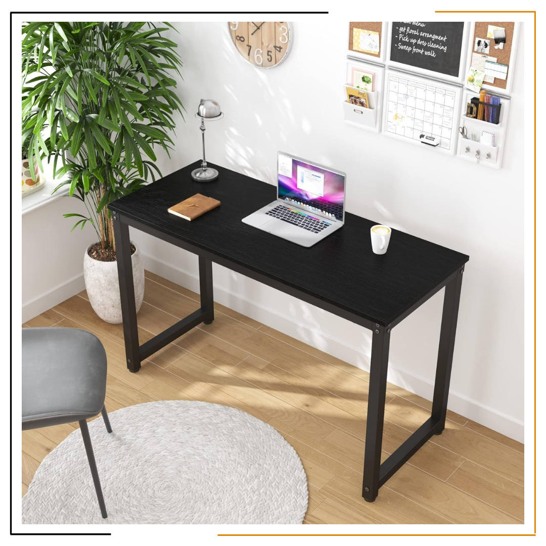 Modern Minimalist Black Desk for Home Office and Study Spaces A sleek, modern black desk set up with a laptop, notebook, coffee mug, desk lamp, wooden wall clock, and green plant, showcasing an organized and elegant workspace.