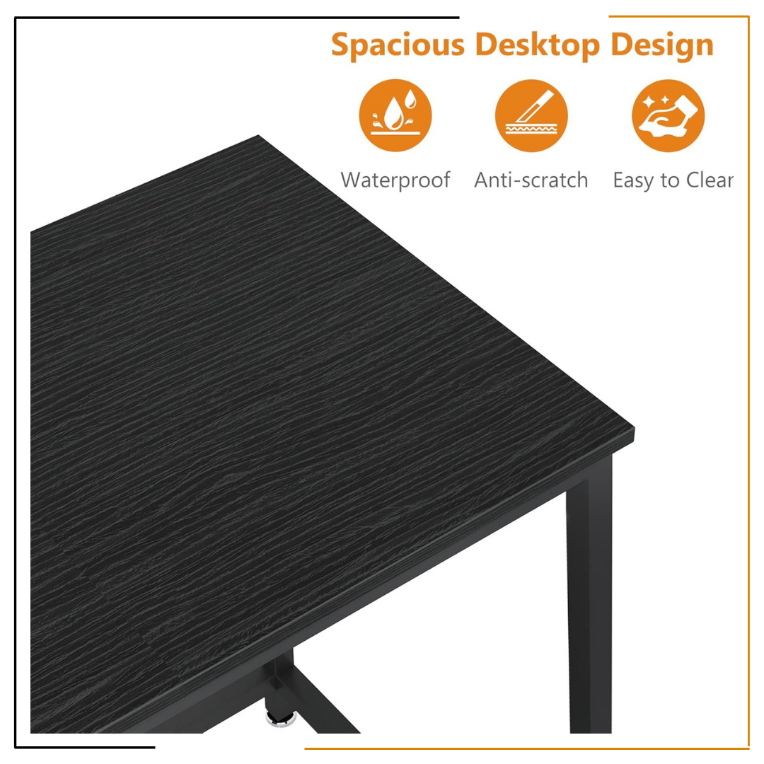 Modern Minimalist Black Desk for Home Office and Study Spaces A sleek, modern black desk set up with a laptop, notebook, coffee mug, desk lamp, wooden wall clock, and green plant, showcasing an organized and elegant workspace.